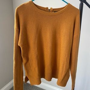 Burnt orange long sleeve sweater with zipper accessory